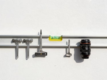 Clean, organized tool layout on a dust-controlled job site, sharp focus on a level resting on a freshly painted wall