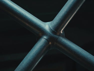 Extreme close-up of a complex architectural node connecting four steel struts, moody lighting with sharp cyan highlights, ultra-sharp details