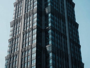 High-contrast chiaroscuro photo of a massive cantilevered steel joint of a modern skyscraper, cool cyan ambient light cutting through deep shadows, ultra-sharp details, 35mm lens