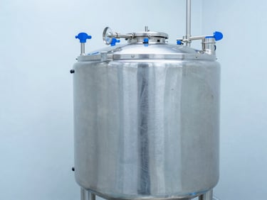 Stainless steel veterinary product mixing tank in a sterile facility, cool white lighting, wide angle, 35mm, with focus on process