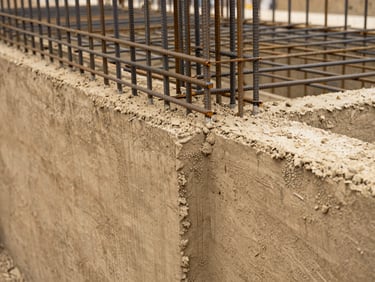 Close-up of structural concrete repair work, steel reinforcement bars visible, industrial maintenance environment, sharp focus, 35mm photography