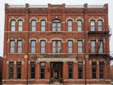 Straight-on architectural elevation of a historic St. Louis red brick facade in Clayton, crisp morning overcast daylight, sharp focus on masonry textures.