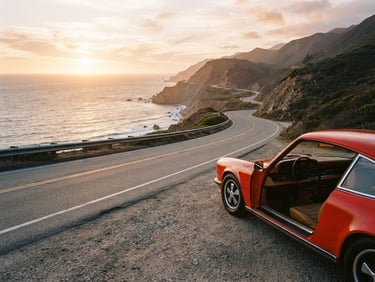 First-person perspective of a winding coastal road at golden hour, with a classic car parked on the shoulder, expansive ocean view, warm editorial travel photography, 35mm film aesthetic