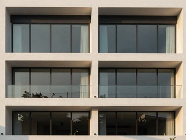 Symmetrical modern minimalist shophouse building facade, clean glass windows, daytime architectural shot