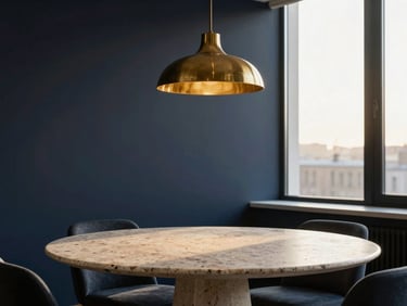 Minimalist luxury apartment dining room, travertine stone table, brass pendant light, soft natural light from a high window