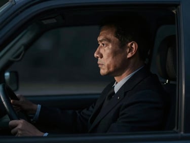 Clean-cut security specialist in a dark suit, profile view, looking out of a vehicle window, low-key lighting, cinematic, sharp focus