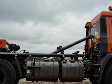Close-up of a heavy-duty prime mover truck chassis, industrial steel details under dramatic overcast daylight, 35mm film grain