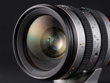 Macro close-up of a high-end cinema lens, reflection of studio lighting on glass, dark background, technical silver-gray details.