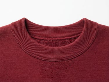 clean studio product photography, close-up of a heavy-gauge deep red cotton neckline, crisp studio light, sharp focus, neutral white background, 50mm