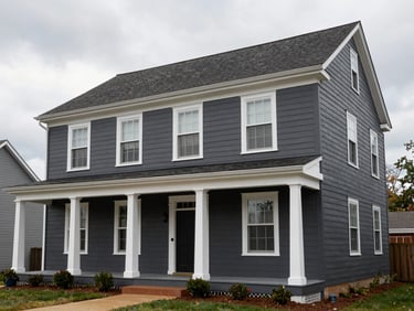 Wide environmental shot of a two-story Virginia colonial exterior after full repaint, white trim against dark gray body, overcast afternoon light, clean fascia and soffit lines visible, no people