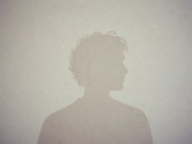 Artistic minimalist portrait silhouette of Luiz, soft shadow on a textured off-white plaster wall, desaturated earth tones, contemplative composition, 35mm film