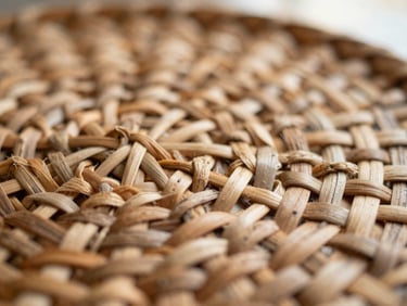 Macro shot of hand-woven rattan textures, showing the intricate knots and natural imperfections, warm morning light, shallow depth of field