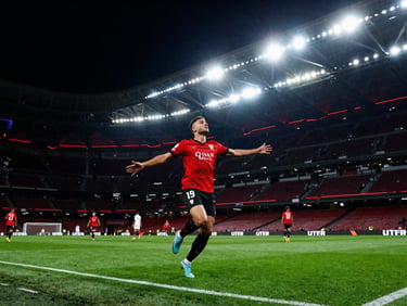 Sevilla FC match action, dynamic angle, dramatic stadium lighting, vibrant neon accents