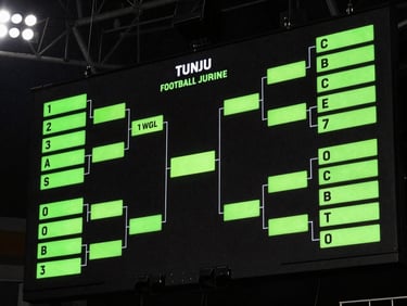 Close-up of a glowing tactical football screen showing simulated tournament brackets and neon green stats, high-contrast dark tones.