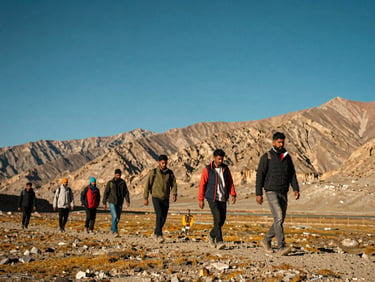 Group of Indian friends hiking together in Ladakh mountains, clear blue sky, rugged landscape, bright daylight