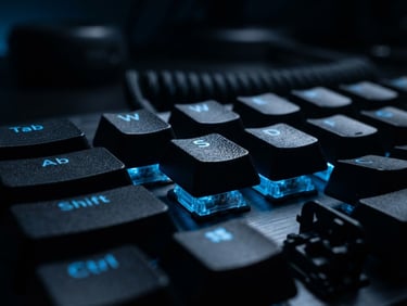 Extreme close-up macro shot of a mechanical keyboard under moody electric blue rim lighting, dark high-contrast studio setting, shallow depth of field, 50mm lens