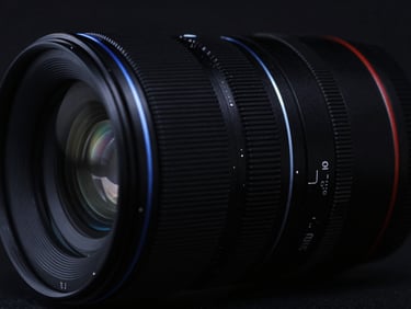 Moody cinematic technology photography, low-key dark studio lighting, abstract dark glass textures reflecting sharp electric blue rim light, sharp details, 50mm lens