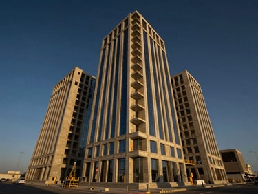 Wide-angle architectural perspective of a Saudi commercial building under construction, golden hour sunlight casting dramatic shadows on concrete structures, deep navy sky, sharp focus, 35mm lens.