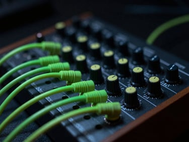Close-up of a modular synthesizer patch bay with neon green cables connected, low-key studio lighting, high contrast, 35mm photography