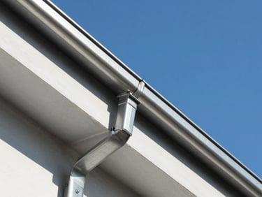 Sleek modern zinc gutter installation on a clean roof edge, bright daylight, sharp architectural detail