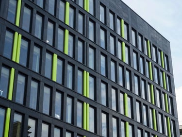 Architectural detail of a modern corporate distribution headquarters, high contrast, cool daylight, 35mm