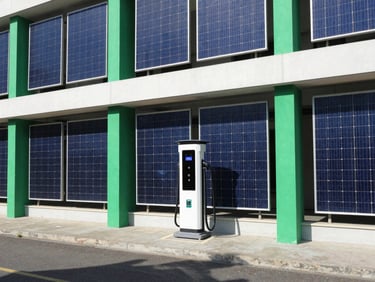 Electric vehicle charging station integrated into a modern building facade, powered by solar, sharp shadows, emerald green accents.