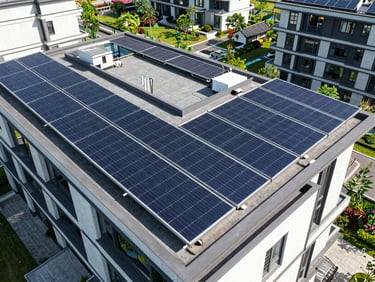 Aerial drone shot of a modern residential rooftop with a sleek, high-efficiency solar array, bright daylight, sharp shadows, wide architectural angle.