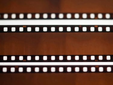 Detailed macro shot of a strip of film negatives, showing individual frames, shallow depth of field.