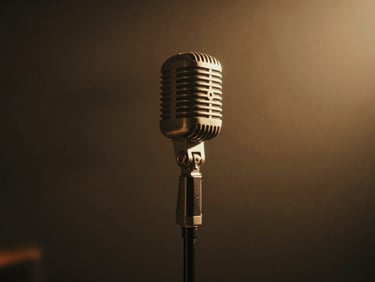 Vintage studio microphone on a stand, soft backlighting, warm golden haze, deep shadows.