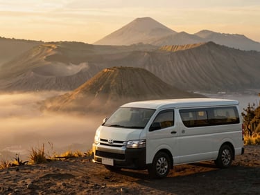 Pristine Toyota Hiace parked near Mount Bromo at sunrise, golden light, misty caldera landscape, warm editorial travel photography