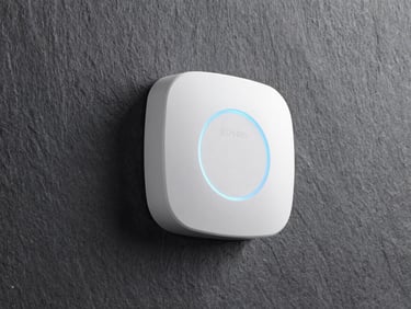Sleek wall-mounted white disc access point glowing with a soft blue LED ring on a dark slate wall, clean architectural daylight, 35mm
