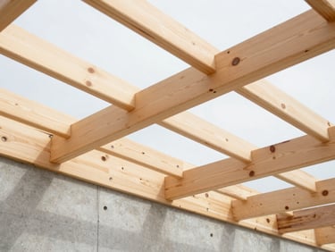 Low angle shot of a newly installed wooden roof structure with laminated timber beams, clean joints, bright natural light filtering through, sharp details.