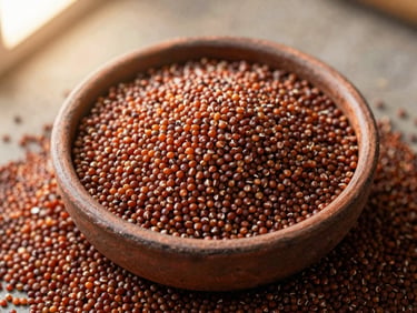 Overhead flat-lay of raw red finger millet grain in a rustic clay bowl, soft morning light.