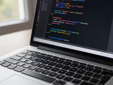 Close-up of a laptop keyboard with a terminal window open showing JavaScript function output, cool natural window light from the left, dark code editor theme visible on screen