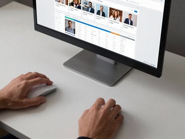 Overhead studio shot of a desk with a monitor showing a social media analytics dashboard, hands hovering over a wireless mouse, cool overhead light, high contrast neutral surface