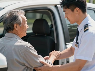 A close-up of a professional driver in a neat uniform offering a supportive arm to an elderly passenger stepping safely into a clean vehicle, warm natural daylight.