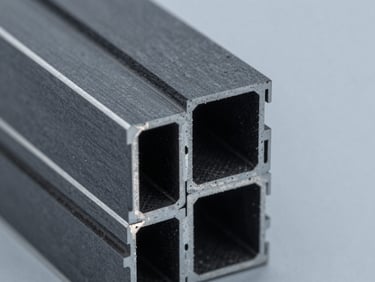 Sharp macro technical close-up of a dark grey extruded PVC profile edge, cool factory daylight, high-contrast slate tones, 35mm.