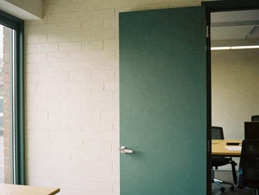 Architectural detail of a clean, modern brick workspace in the Midlands, soft overcast daylight, natural shadows, 35mm film grain