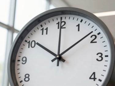 A clock face showing time passing, symbolizing efficiency and clear timelines. Bright editorial photography, natural window light, clean corporate tones.