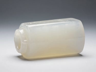 Side-profile close-up of translucent resin printed part on white ground under even studio light, smooth surface finish visible, tiny internal geometry revealed through material clarity