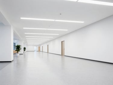 Wide architectural shot of a clean, modern educational facility hallway, crisp lighting, polished floors.