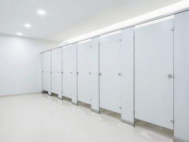 Bright high-key shot of a pristine commercial restroom with gleaming floors and crisp interior lighting.