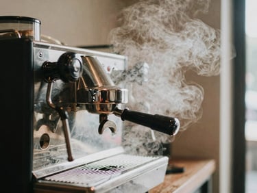 A close-up shot of a modern manual lever espresso machine in a minimalist Bangkok cafe, humid haze, steam rising.
