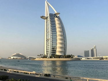 Architectural elevation of a modern high-rise facade in Dubai, geometric concrete and glass patterns, soft low-contrast morning light.