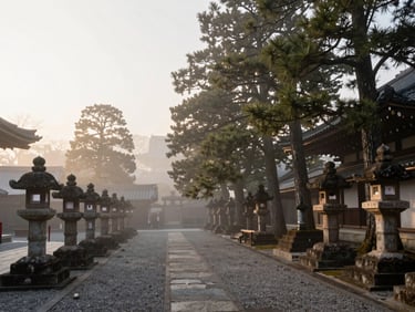 Wide environmental frame of a Japanese temple courtyard at morning mist, stone lanterns to the left third, cedar trees receding into soft fog on the right, golden diffused light from above — quiet atmosphere, no people