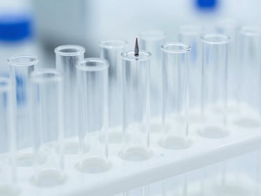 Row of sterile plastic pathology test tubes in a rack, sharp macro focus, bright laboratory background