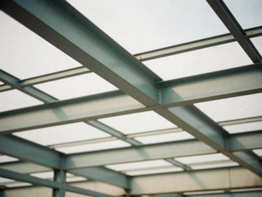 Architectural detail of structured steel beams casting sharp shadows in an industrial workspace, diffused overcast daylight, muted tones