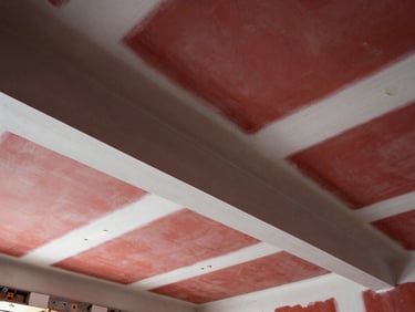 Freshly taped and mudded drywall joints on a clean high ceiling, smooth compound lines, architectural lighting
