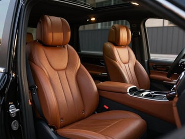 Luxury interior of a black Mercedes Vito, close-up of premium cognac leather seats, ambient lighting, high-end multimedia screen, 35mm