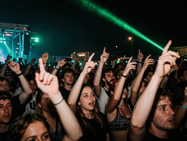 Gritty wide-angle flash photograph of a packed UK music festival crowd at night, hands in the air, glowing neon green and cyan stage lights, high contrast.